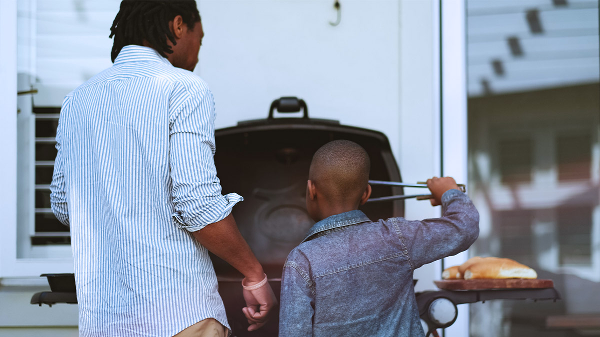 person and child at a bbq